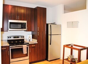 Enjoy cooking in this kitchen with a gas stove, microwave, and refrigerator.