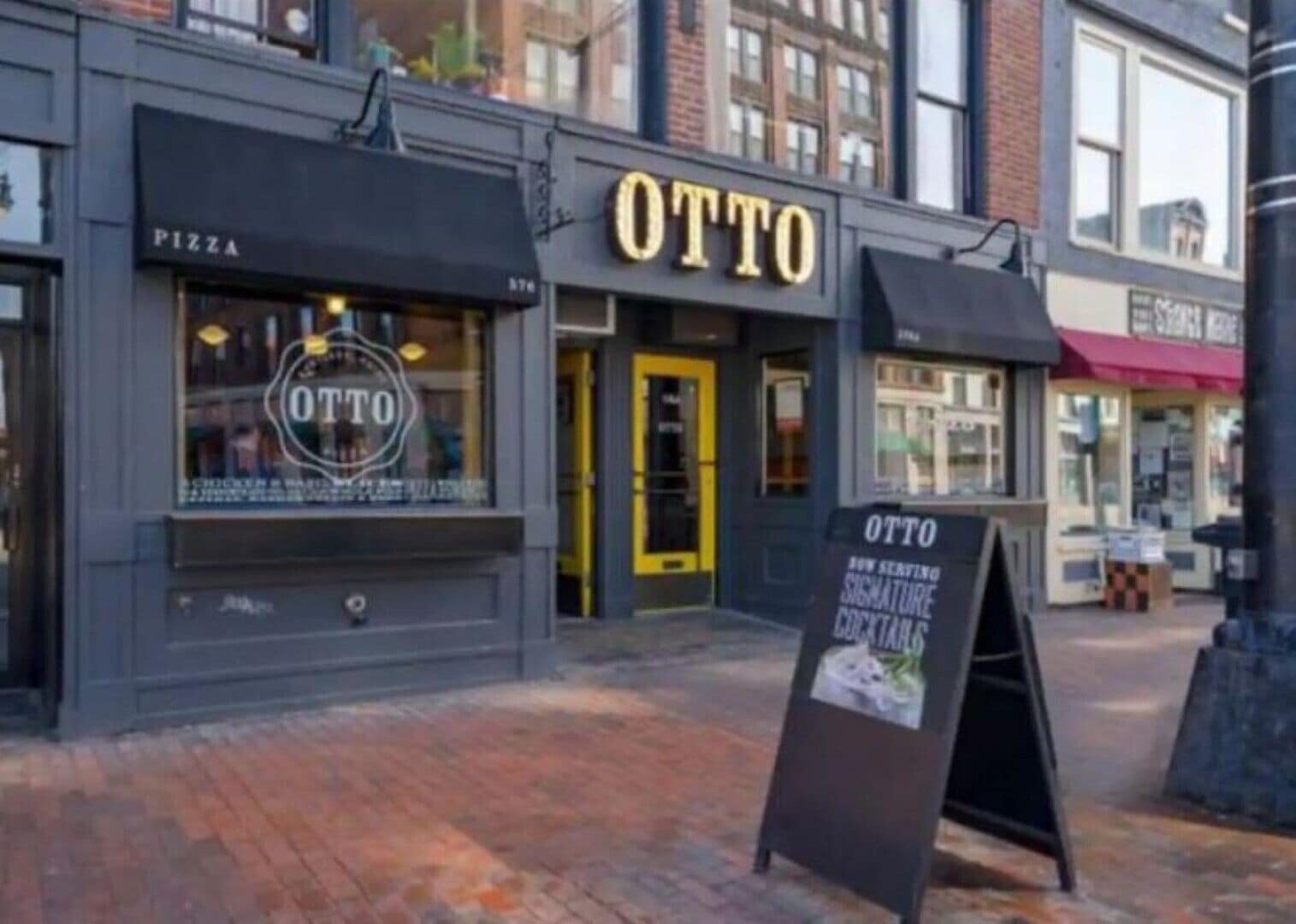 A storefront with a sign reading "OTTO" and a window display.