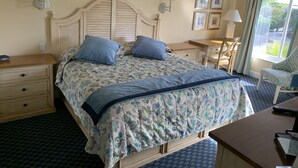 A bedroom with a bed, bedside tables, a desk, a chair, and a ceiling fan. - Wonderful Sanibel Island condo. 2 bed 2 bath. Sleeps 6. Weekly rental.  (Sanibel)