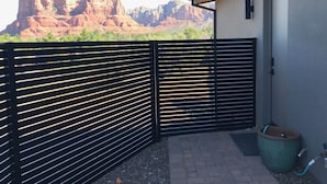 A gated patio with a view of red rock formations.