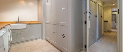 Enjoy cooking and dining in this well-organized kitchen with washing machine, stainless steel sink, and ample counter space.