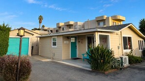 A two-story building with a green door, a sign reading 'BEACH,' and a number '254' on the side. - Walk to Embarcadero + Kids Dream Yard + Pool Table (Morro Bay)