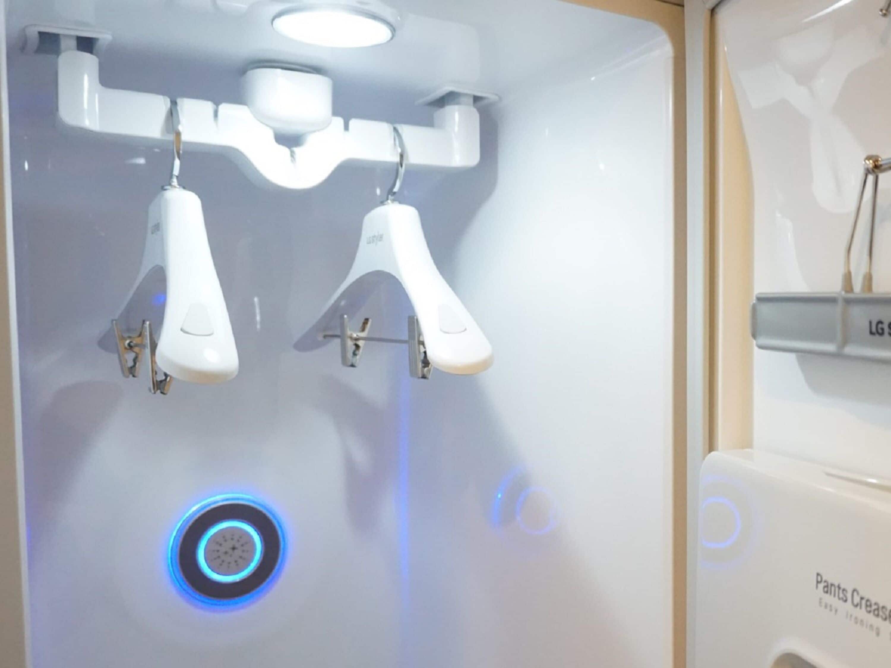 A bathroom with a modern design, featuring a sink with a mirror and a wall-mounted faucet.