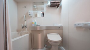 A modern bathroom with a bathtub, toilet, and sink. - Maruni Hotel Ise (Ise)