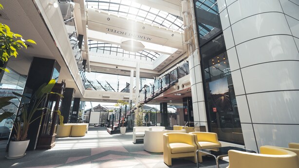 A spacious lobby with a high ceiling, modern seating areas, and a visible hotel name. - Maruni Hotel Ise (Ise)
