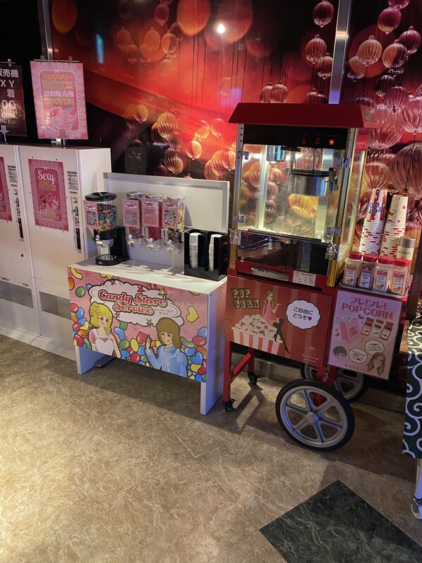 A candy store kiosk with a popcorn machine and a drink dispenser. - Hotellapia - Adults Only (Tokyo)