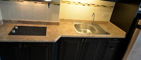 Condo, 1 Bedroom | Private kitchen | Microwave, electric kettle, dining tables