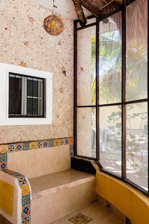 A room with a window, a woven ceiling light, a tiled bench, and a patterned tile border. - Room-antigua Lodge, Away From the Crowds (El Cuyo)