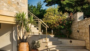 A stone staircase leading to a wooden deck with potted plants. - Palladio Villa Roussospiti (Rethymno)