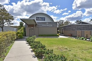 A building with a sign for IronBark Hill BREWHOUSE and Peter Drayton Wines.