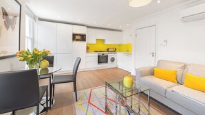 A modern apartment with a dining area, kitchen, and living space. - Marylebone - Crawford Street apartments by Viridian Apartments (London)