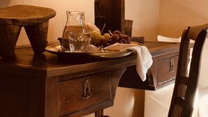 A wooden table with a pitcher, glasses, grapes, and a cloth. - OAR Cottage (Garai)