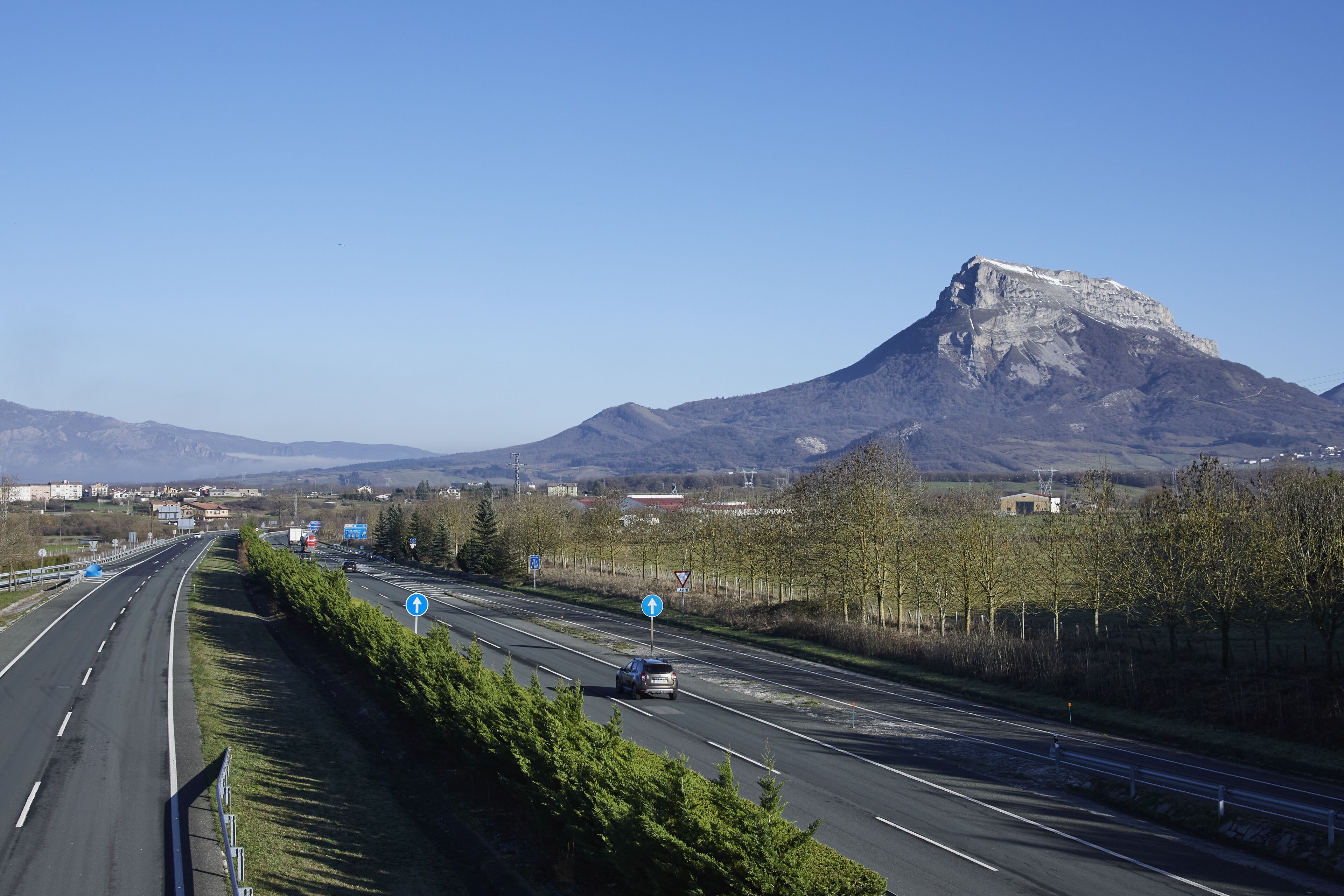 A highway with a mountain in the background.