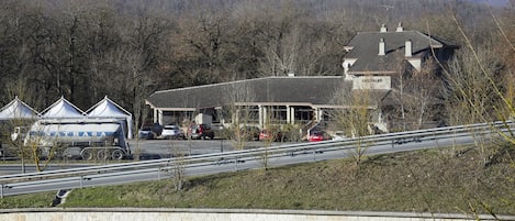 A building with a sign that reads "ARTZALD" and a large truck parked in front.