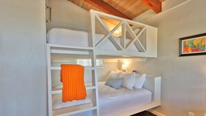 A bunk bed with a ladder, white bedding, and a single orange blanket. - Quaint Cottages in Canyon Lake! Perfect for kids! (Canyon Lake)