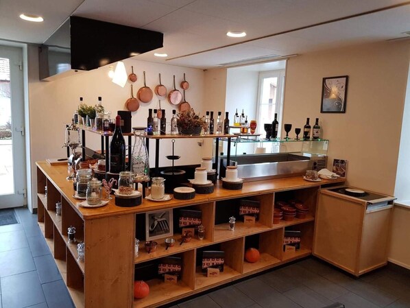 A kitchen with a wooden counter, various kitchen utensils, and a sink. - Hotel de Ville (Les Verrieres)