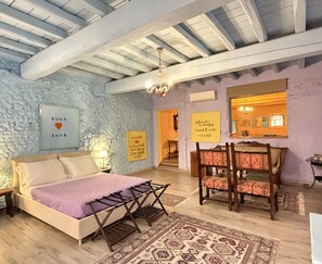 A bedroom with a bed, a wooden chair, a rug, and a wall with motivational quotes.