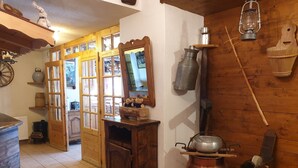 A rustic kitchen with wooden cabinets, a wooden stove, and a copper pot on the stove. - Apartment for 20 people with Wi-Fi, near Linga gondola - Chatel Reservation (châtel)