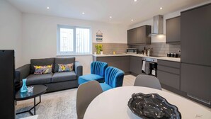 A modern apartment with a living area, kitchen, and dining space. - Windmill House Apartment 4 (Lytham Saint Annes)