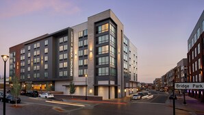 A modern hotel with multiple floors, large windows, and a prominent sign for 'Springhill Suites by Marriott'.