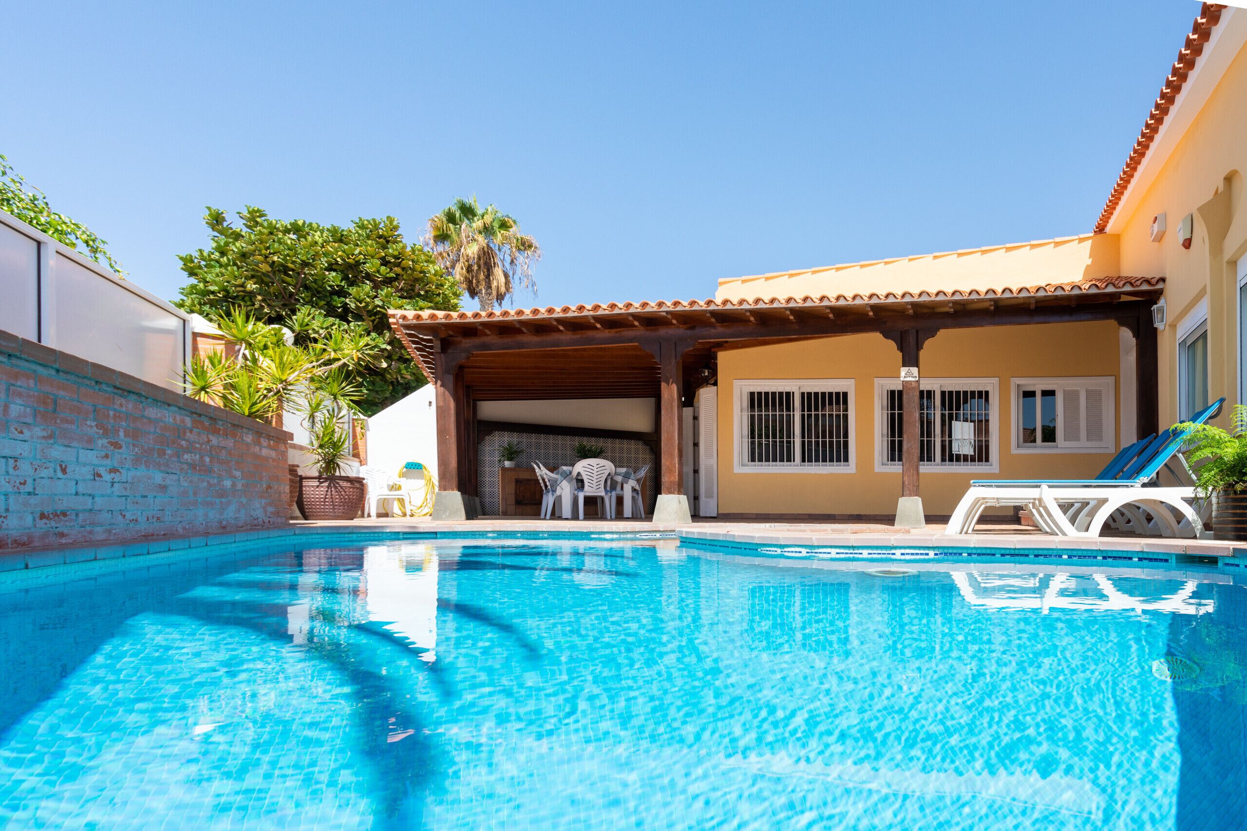 A heated pool, sun loungers