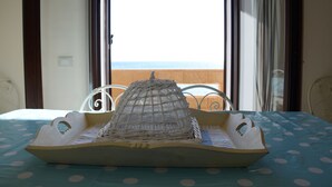 A bed with a polka dot bedspread and a white decorative item on it. - Apartment by the sea (Augusta)