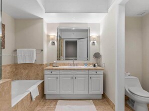 Bathtub, hair dryer, towels, shampoo