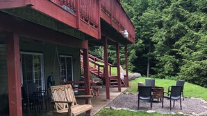 A wooden deck with outdoor seating and a staircase leading to a second level. - Windham Mountain Chalet with Treehouse sleeps 15, Game Room & fireplace (Windham)