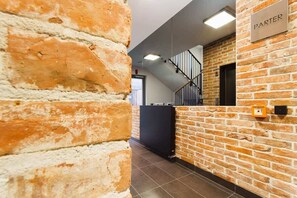 Experience the chic atmosphere of Parter, where exposed brick walls meet minimalist design.