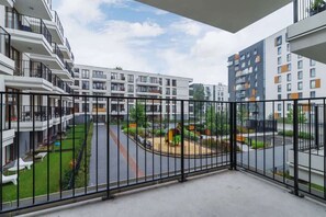 Enjoy a balcony with a view of the well-maintained courtyard and play area.