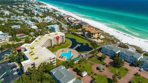 An aerial view of a coastal residential area with a large swimming pool, beachfront properties, and a beach. -  GULF FRONT on 30A with Beach setup! (Santa Rosa Beach)