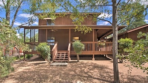 A rustic wooden cabin with a covered porch and a staircase leading to the entrance. - Forest-View Retreat in Payson, Close to Hiking! (Payson)