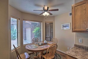 A dining area with a round table, chairs, a ceiling fan, and windows with blinds. - Forest-View Retreat in Payson, Close to Hiking! (Payson)