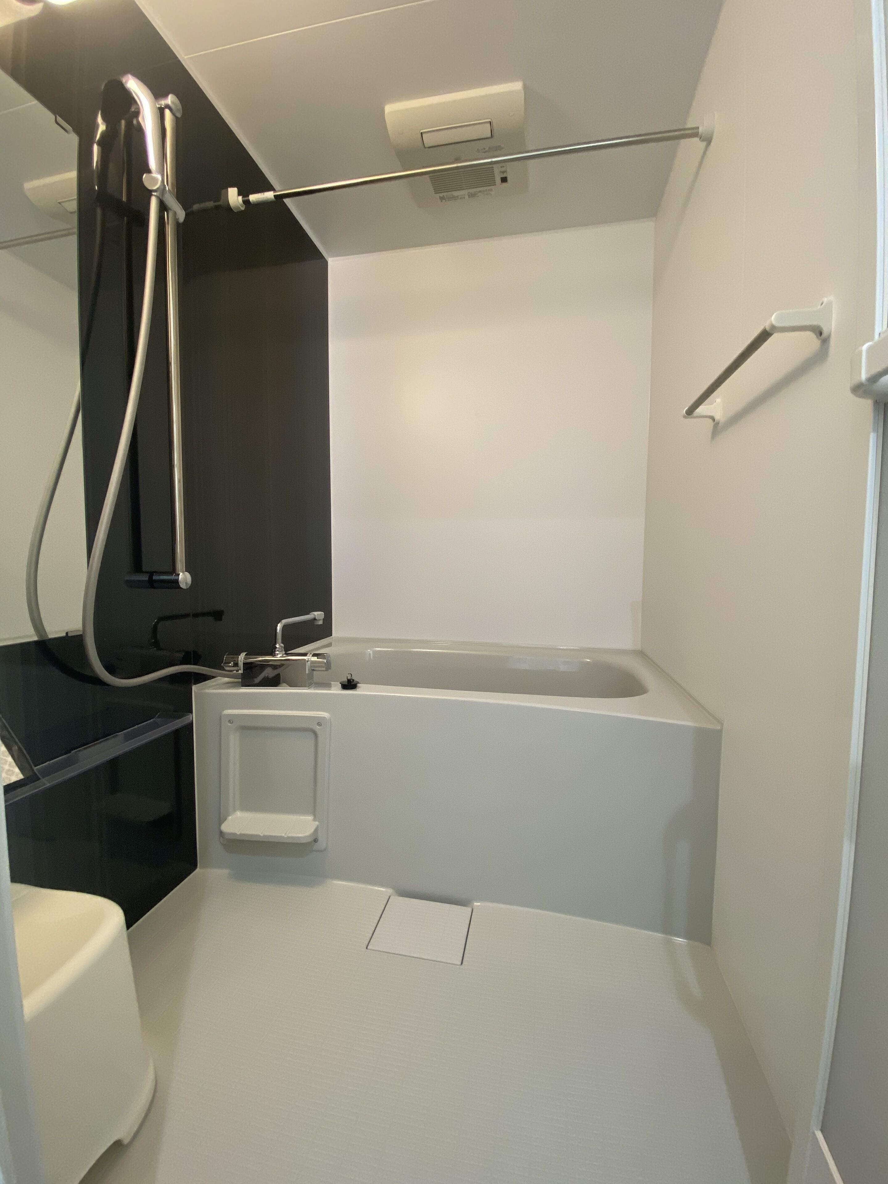 A modern bathroom with a corner shower, a built-in toilet, and a bathtub.