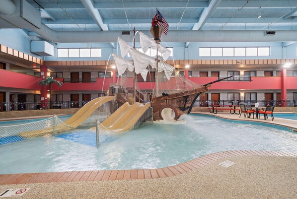 An indoor water park with a pirate ship play area, slides, and a pool. - Ramada by Wyndham Sioux Falls Arpt & Suites (Sioux Falls)