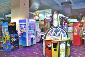 A variety of arcade games in a brightly lit indoor setting. - Ramada by Wyndham Sioux Falls Arpt & Suites (Sioux Falls)