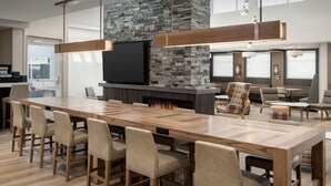 A modern kitchen with a large island, a built-in fireplace, and a flat-screen TV. - Residence Inn by Marriott Lubbock-University Area (Lubbock)