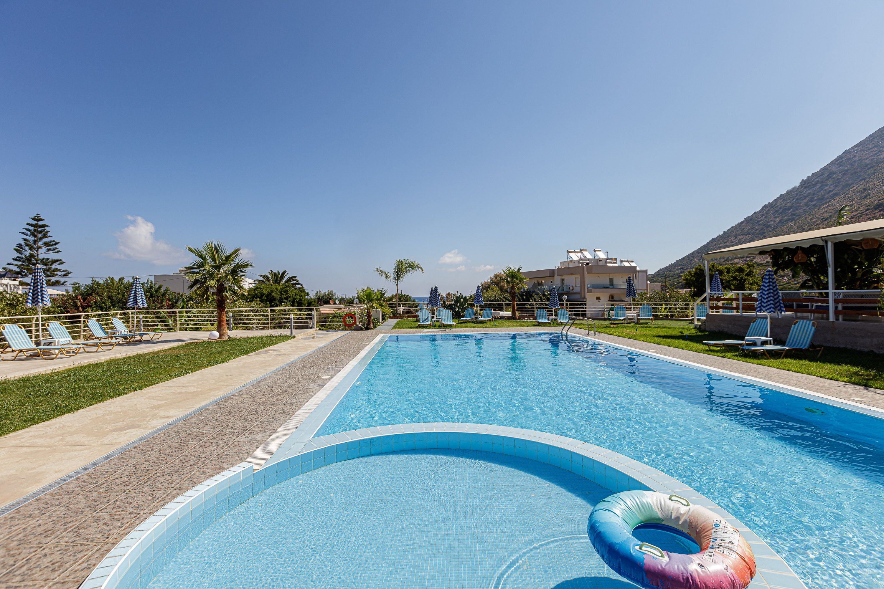 Seasonal outdoor pool, pool umbrellas, pool loungers