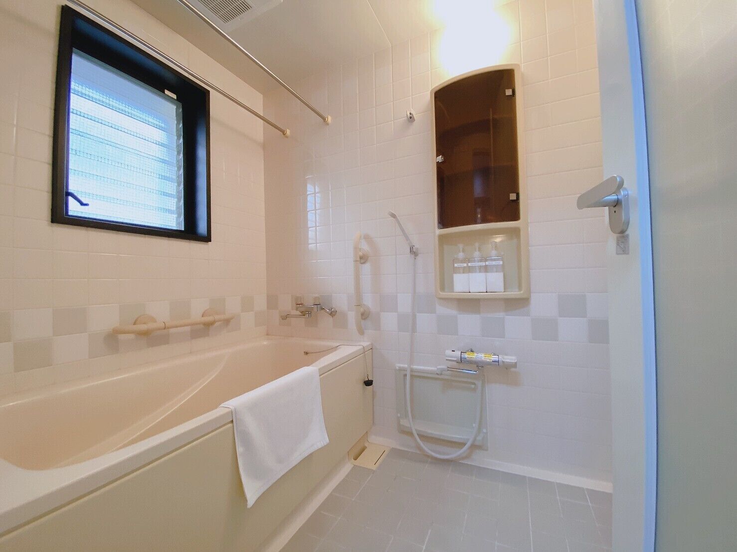 A modern bathroom with a bathtub, a shower, and a vanity with a mirror.