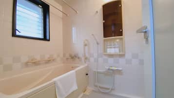 A modern bathroom with a bathtub, a shower, and a vanity with a mirror.