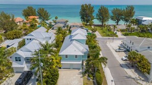 A coastal residential area with houses, a road, and a view of the ocean. - Funky Beach Farmhouse: Beautiful Bay views, heated pool, hot tub, lounge area (Anna Maria)