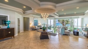 A spacious living area with a round table, a chandelier, and a view of the outdoors. - Silver Beach Towers 1905e 3 Bedroom Condo by RedAwning (Destin)