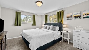 A bedroom with a bed, a nightstand, a dresser, and a TV. - Charming Arvada Home - Walking distance to Olde Town (Arvada)