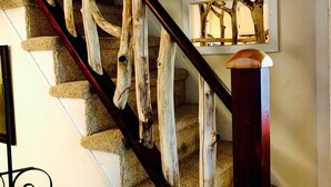 A staircase with wooden handrails and a wall-mounted light fixture. - Beautiful Yr Round Cottage Great Porch, Heart of MTG, Near Hershey, Lititz, Lanc (Mount Gretna)