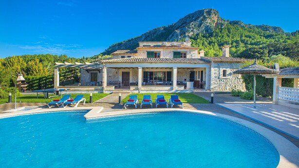 A pool with blue lounge chairs, a stone building with a tiled roof, and a mountainous backdrop. - RAFALET. Charming villa with great pool and spectacular surroundings (Pollensa)