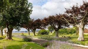 A park with trees, a pathway, and a picnic table. - The Imperial Hotel (Exmouth)