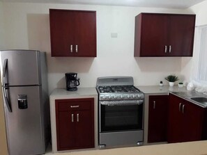 Fridge, stovetop, coffee/tea maker, cookware/dishes/utensils