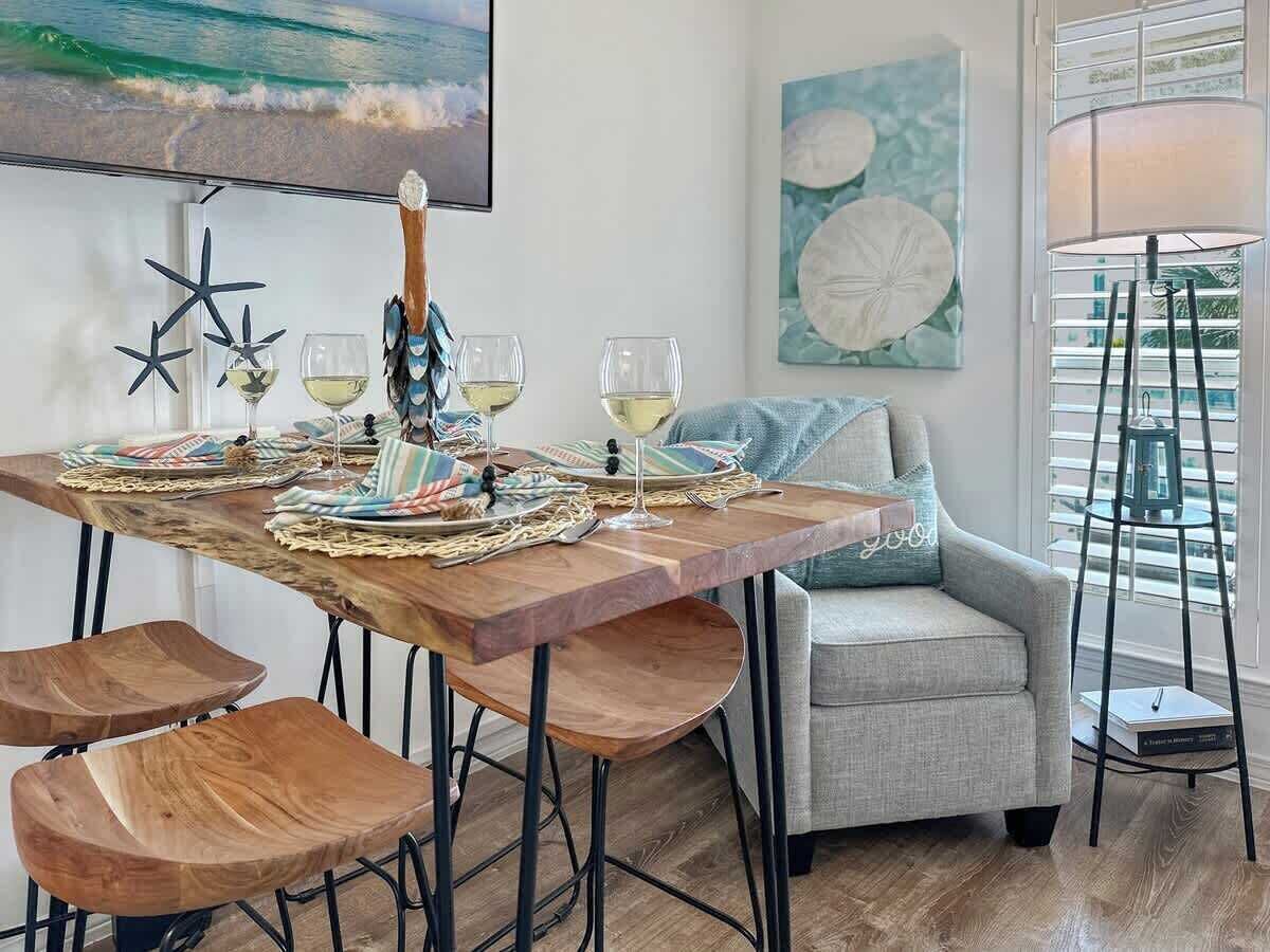 A dining area with a wooden table, chairs, and a sofa.