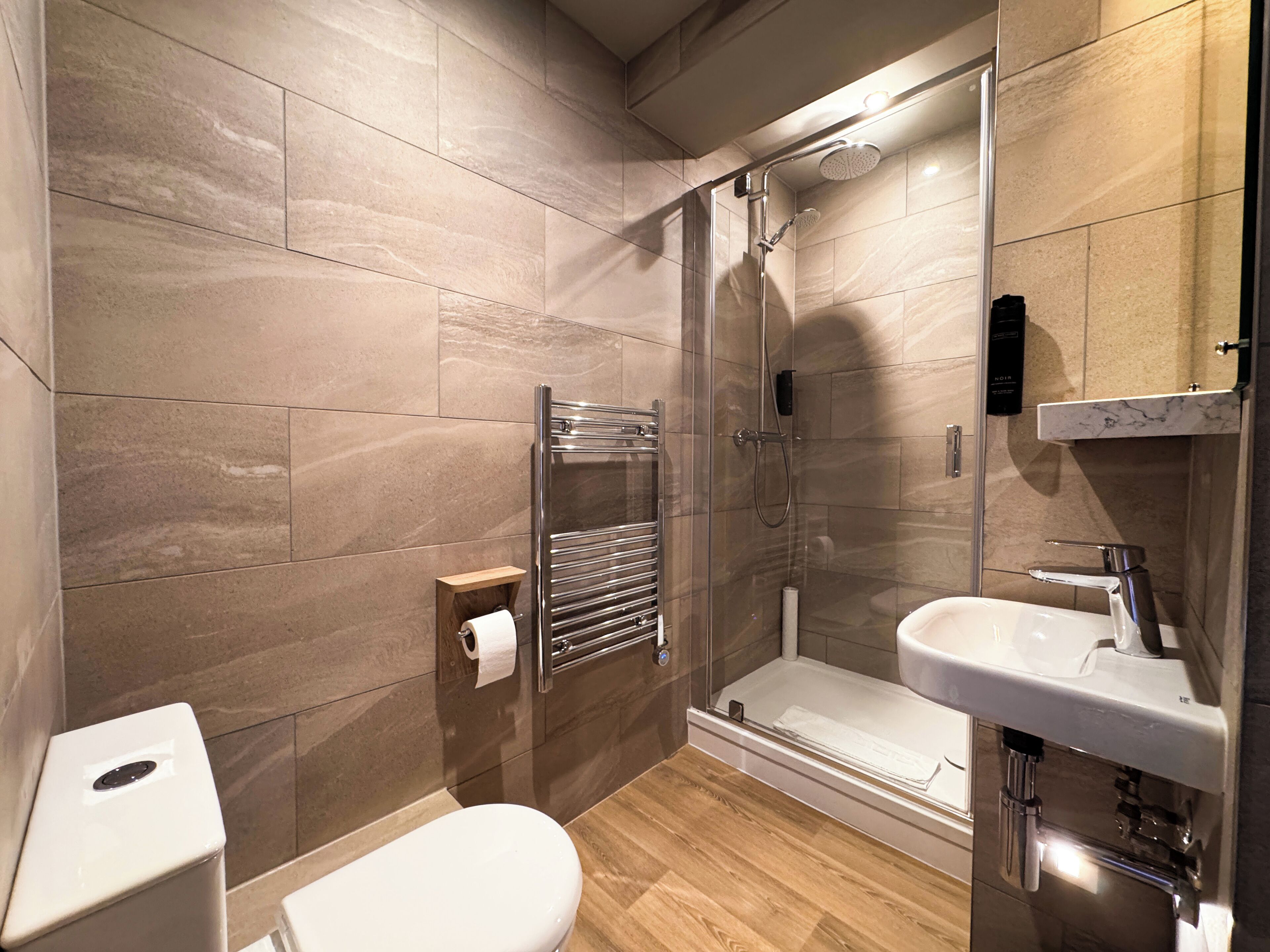 Ein modernes Badezimmer mit Dusche, Toilette und Waschbecken.