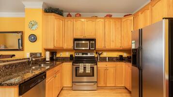 Fridge, dishwasher, coffee/tea maker, cookware/dishes/utensils